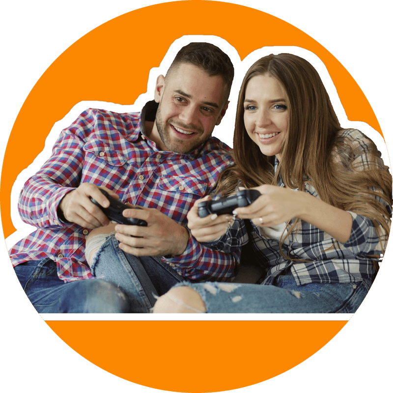 Casal sentado no sofá jogando videogame com controles nas mãos